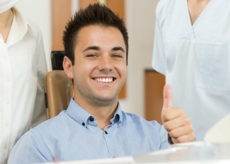 Man giving thumbs up while visiting oral surgery office in Worcester