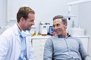 a patient smiling while visiting their dentist 