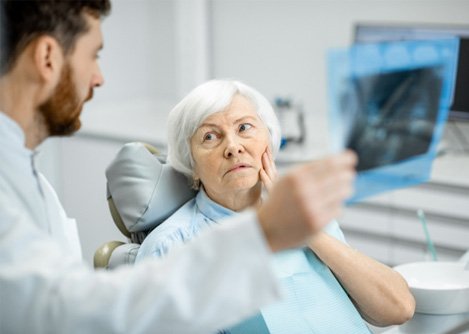 Animated dental implant with abutment and crown being placed in the lower jaw