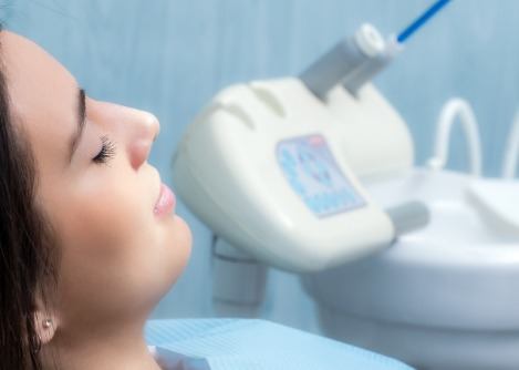 Woman relaxing in dental treatment chair with eyes closed