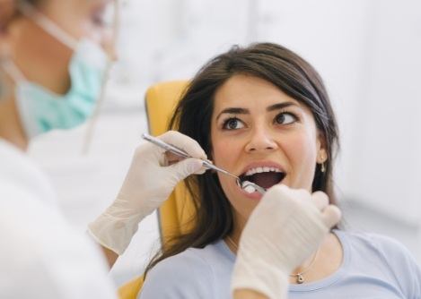 Dentist examining a patient's mouth