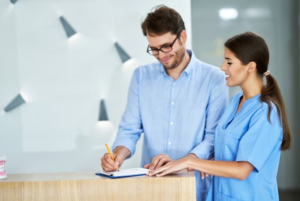 a person paying their dental bill