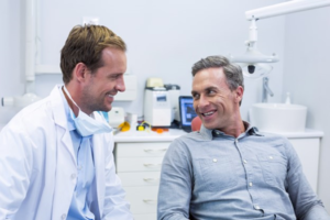 a patient smiling while visiting his dentist